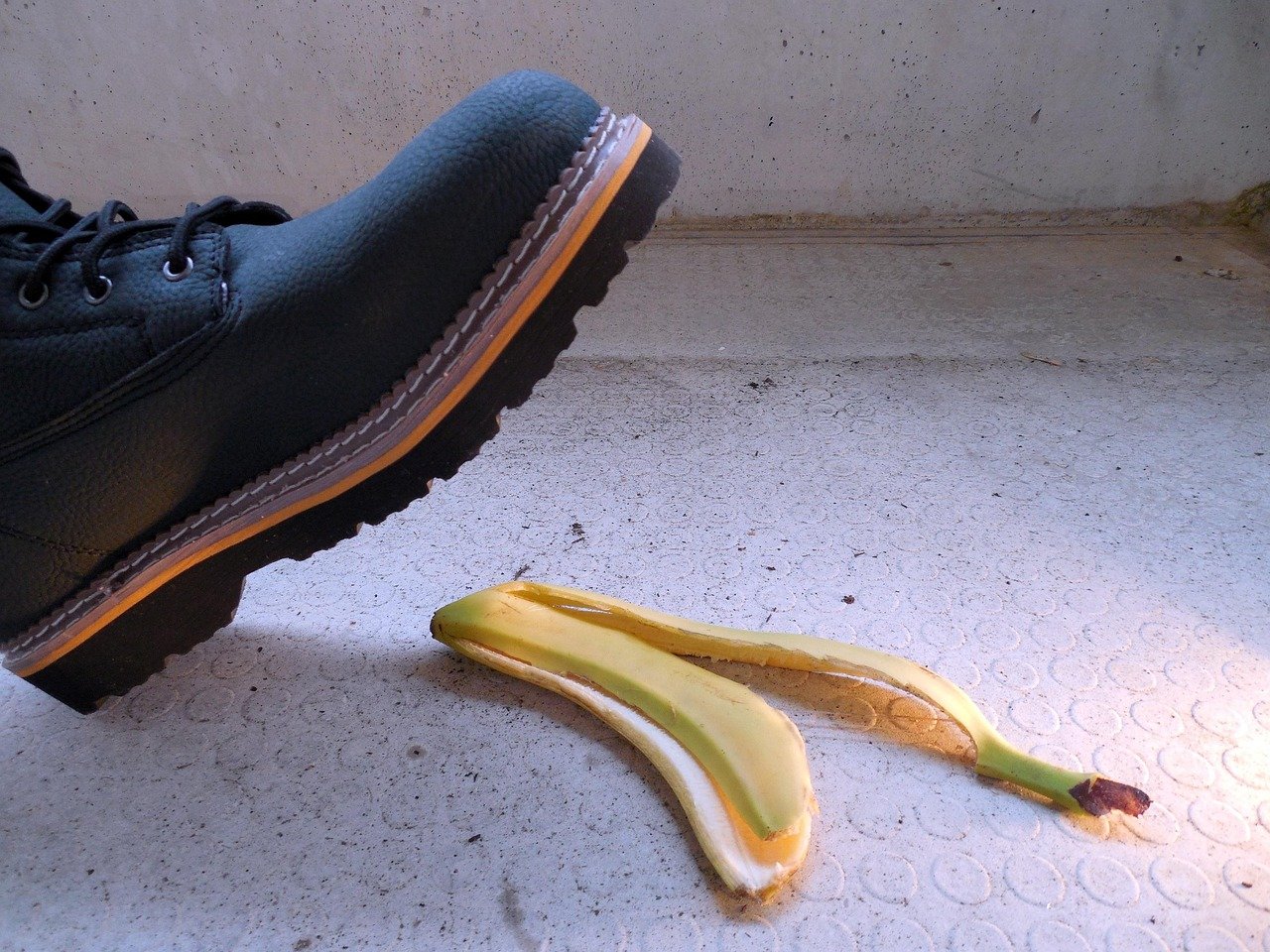 A person about to slip on a banana peel, representing a potential slip and fall injury compensation claim in a public place.