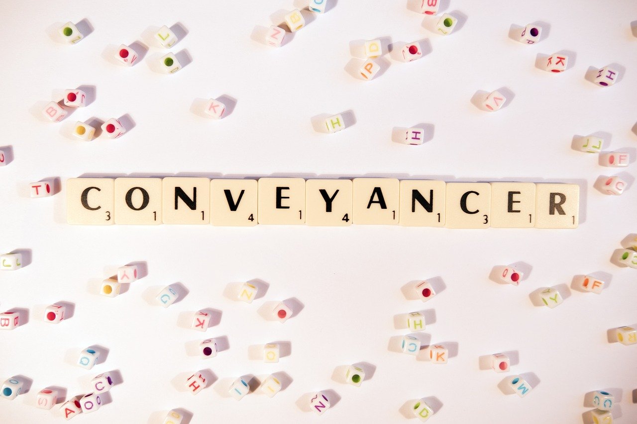 QES conveyancing concept with conveyancer word in scrabble tiles